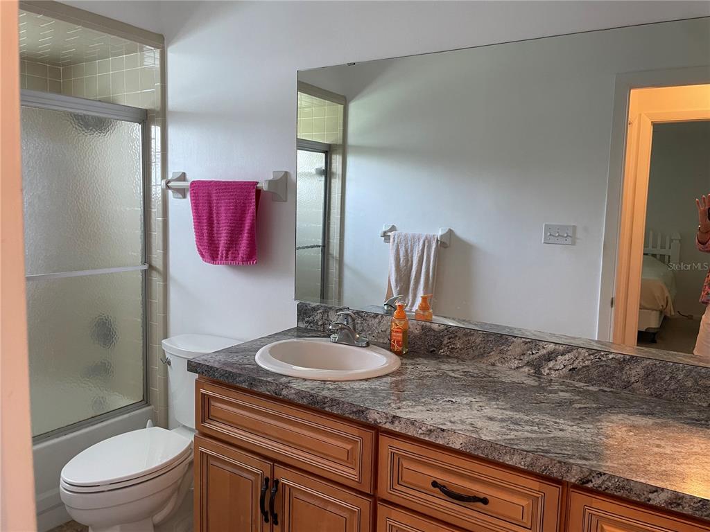 2818 Summit Drive Sebring, FL 33870 - Photo 14 of 28 a bathroom with a granite countertop sink and a mirror
