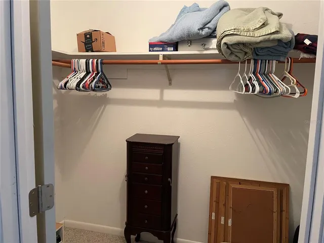 a bathroom with a granite countertop sink mirror vanity and toilet