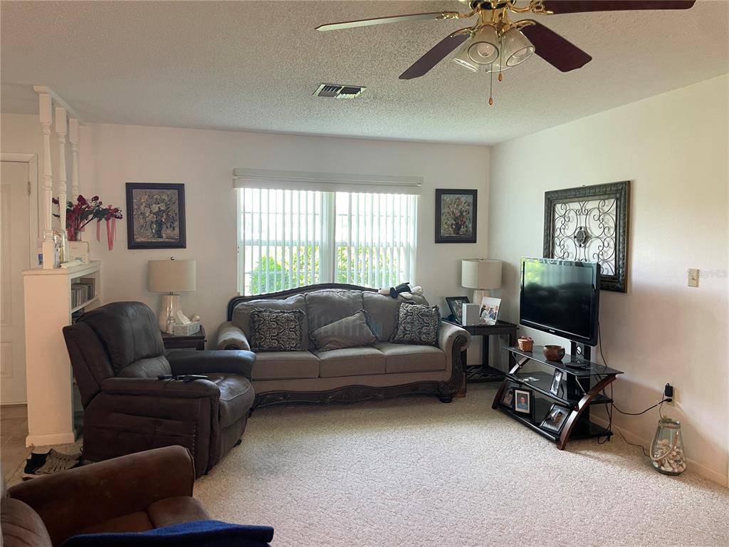 2818 Summit Drive Sebring, FL 33870 - Photo 6 of 28 a living room with furniture and a flat screen tv