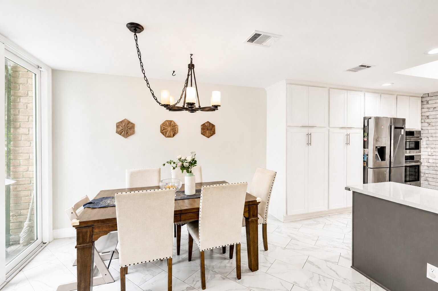 201 Vanderpool Lane, Unit 130 Houston, TX 77024 - Photo 12 of 41 Another view of the breakfast which is adjacent to the kitchen. Built-in cabinetry encapsulates the refrigerator and double oven and provides additional storage that complements the walk-in pantry.