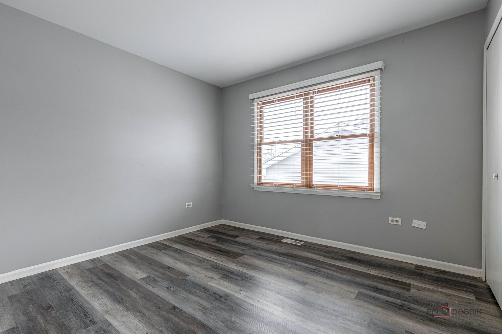 1716 Red Bud Road Bolingbrook, IL 60490 - Photo 20 of 38 a view of a room with wooden floor and windows in it