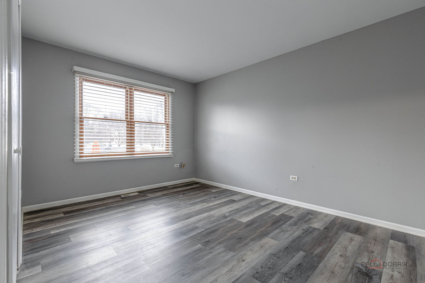 1716 Red Bud Road Bolingbrook, IL 60490 - Photo 21 of 38 a view of an empty room with wooden floor and a window