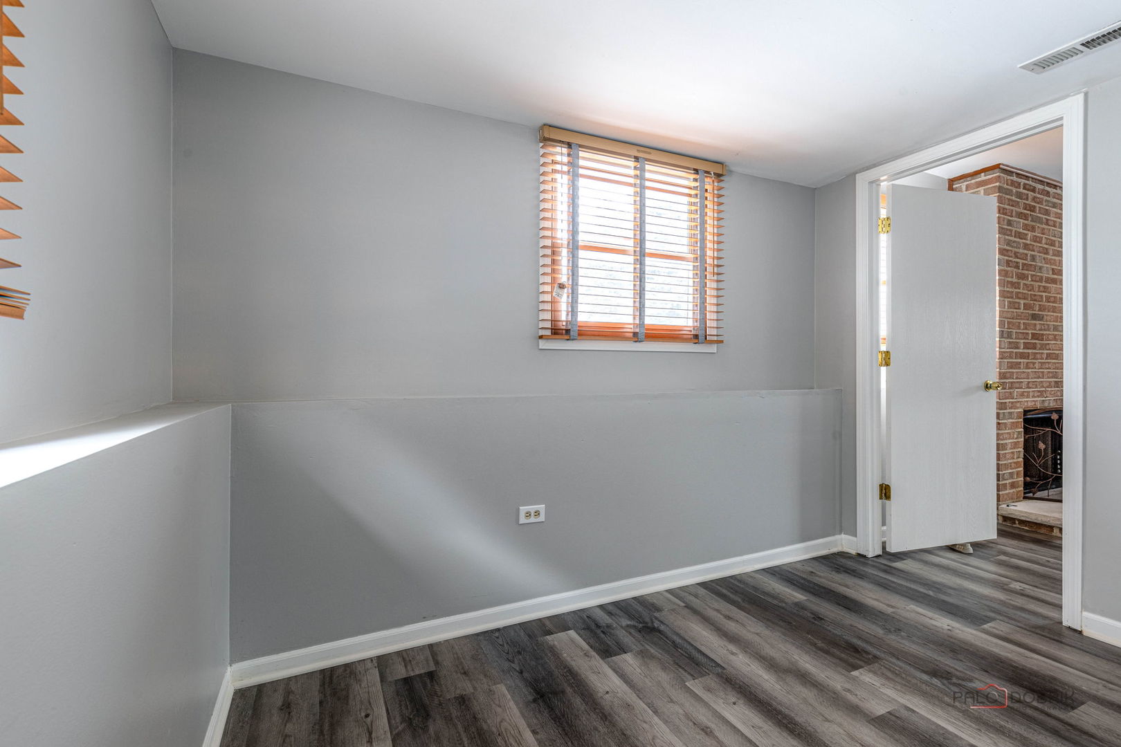 1716 Red Bud Road Bolingbrook, IL 60490 - Photo 22 of 38 an empty room with wooden floor and windows