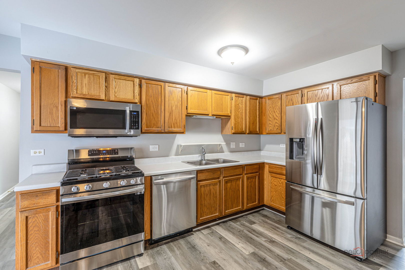 1716 Red Bud Road Bolingbrook, IL 60490 - Photo 9 of 38 a kitchen with stainless steel appliances a stove a sink and a microwave