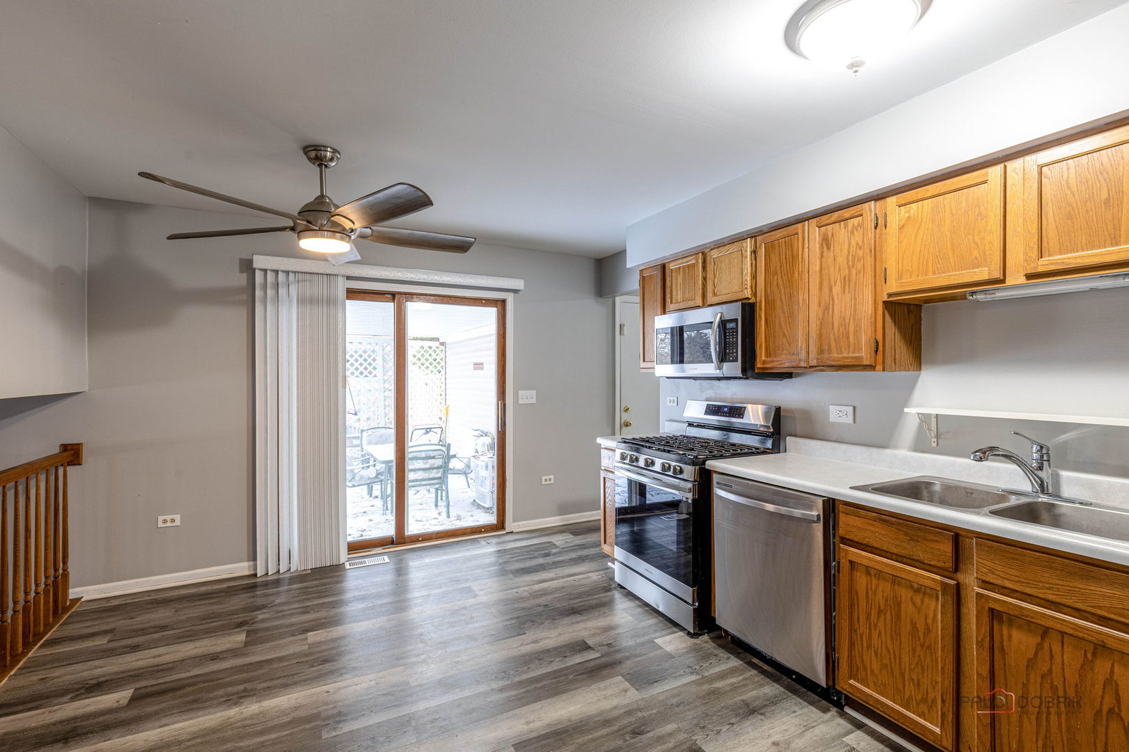 1716 Red Bud Road Bolingbrook, IL 60490 - Photo 10 of 38 a kitchen with stainless steel appliances granite countertop a sink cabinets wooden floor and a window