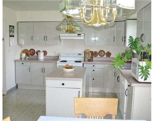 Kitchen. Large Kitchen with lots of work space.  Includes Kitchen Island, Pantry  and separate Dining Area. Attractive Cabinetry, Countertops and Lighting.  Large Window for viewing Exterior. Doors to Garage and Basement.