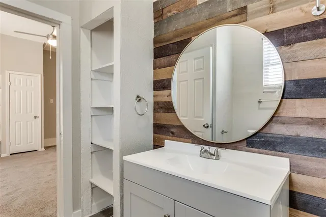 an entryway with wooden floor and mirror