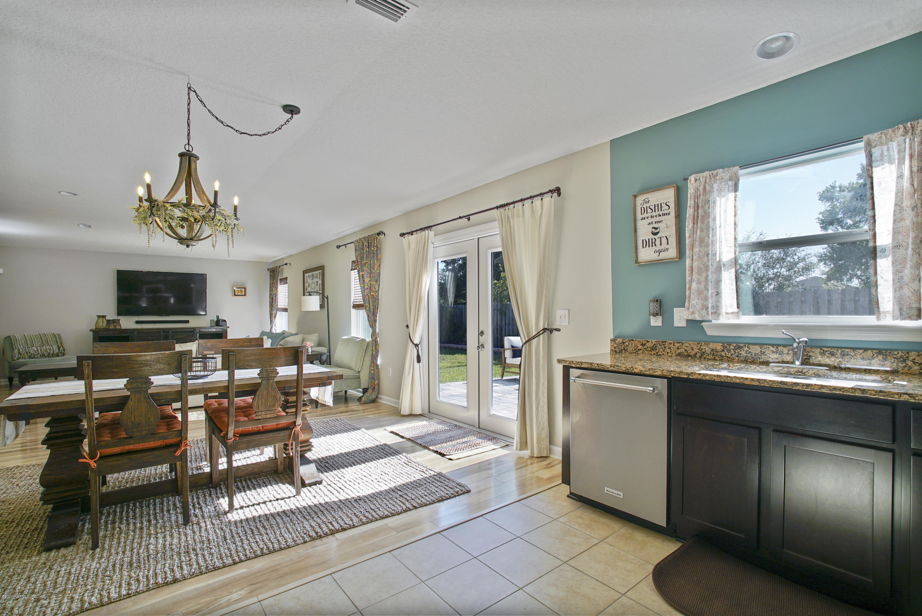 4447 Oak Moss Loop Middleburg, FL 32068 - Photo 11 of 36 a living room with granite countertop furniture a fireplace and a flat screen tv