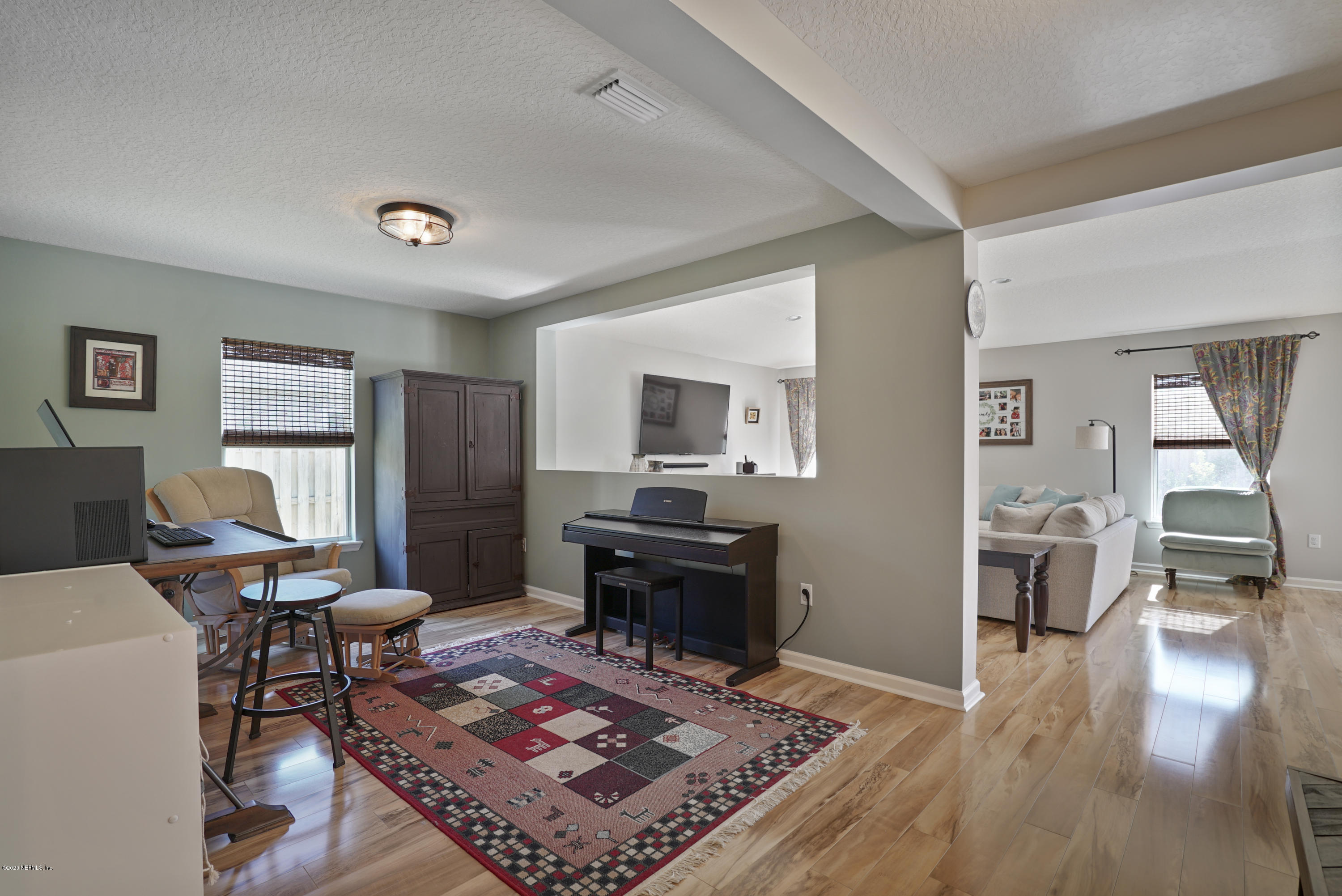 4447 Oak Moss Loop Middleburg, FL 32068 - Photo 12 of 36 a living room with furniture and a wooden floor