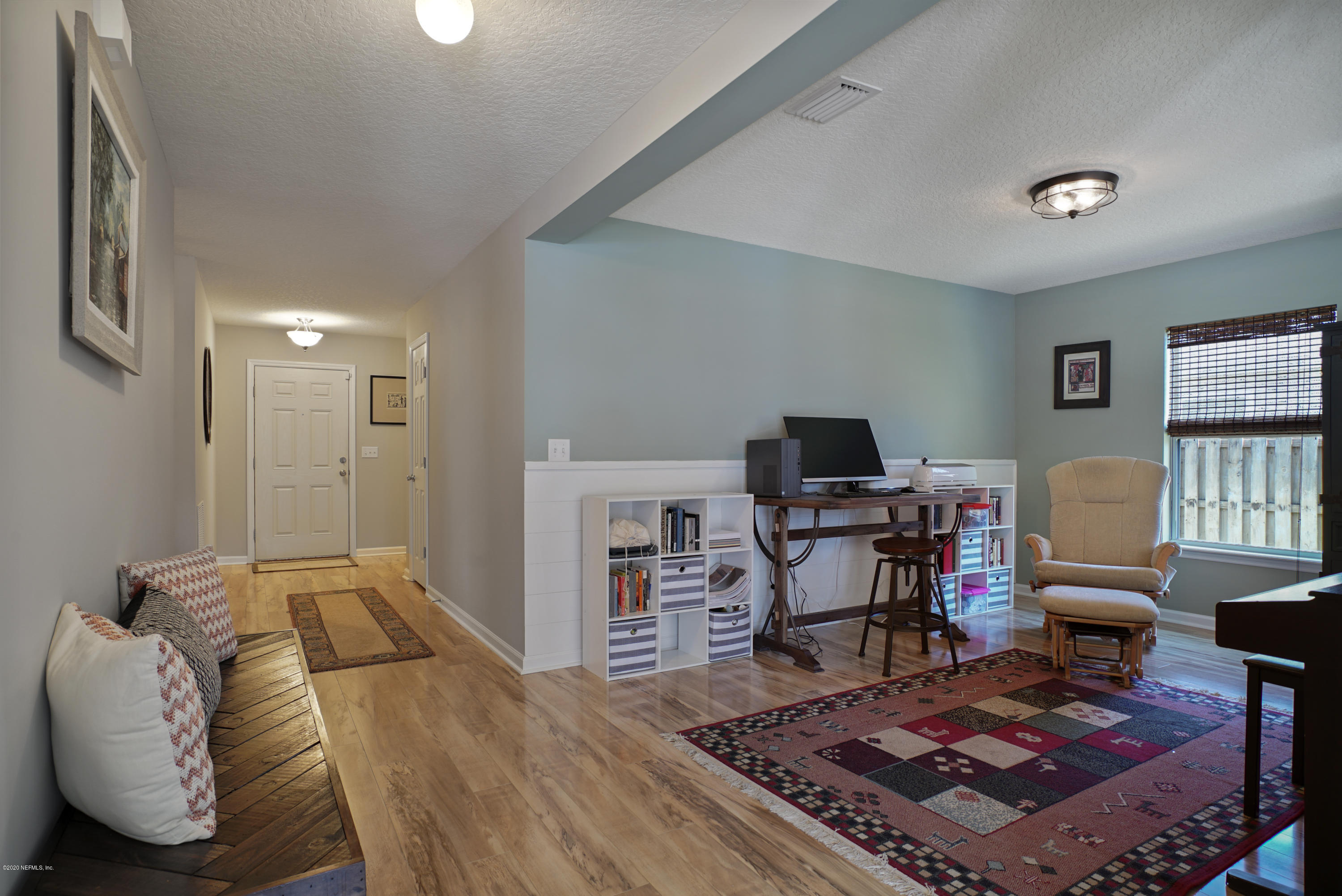 4447 Oak Moss Loop Middleburg, FL 32068 - Photo 13 of 36 a bedroom with furniture and a wooden floor