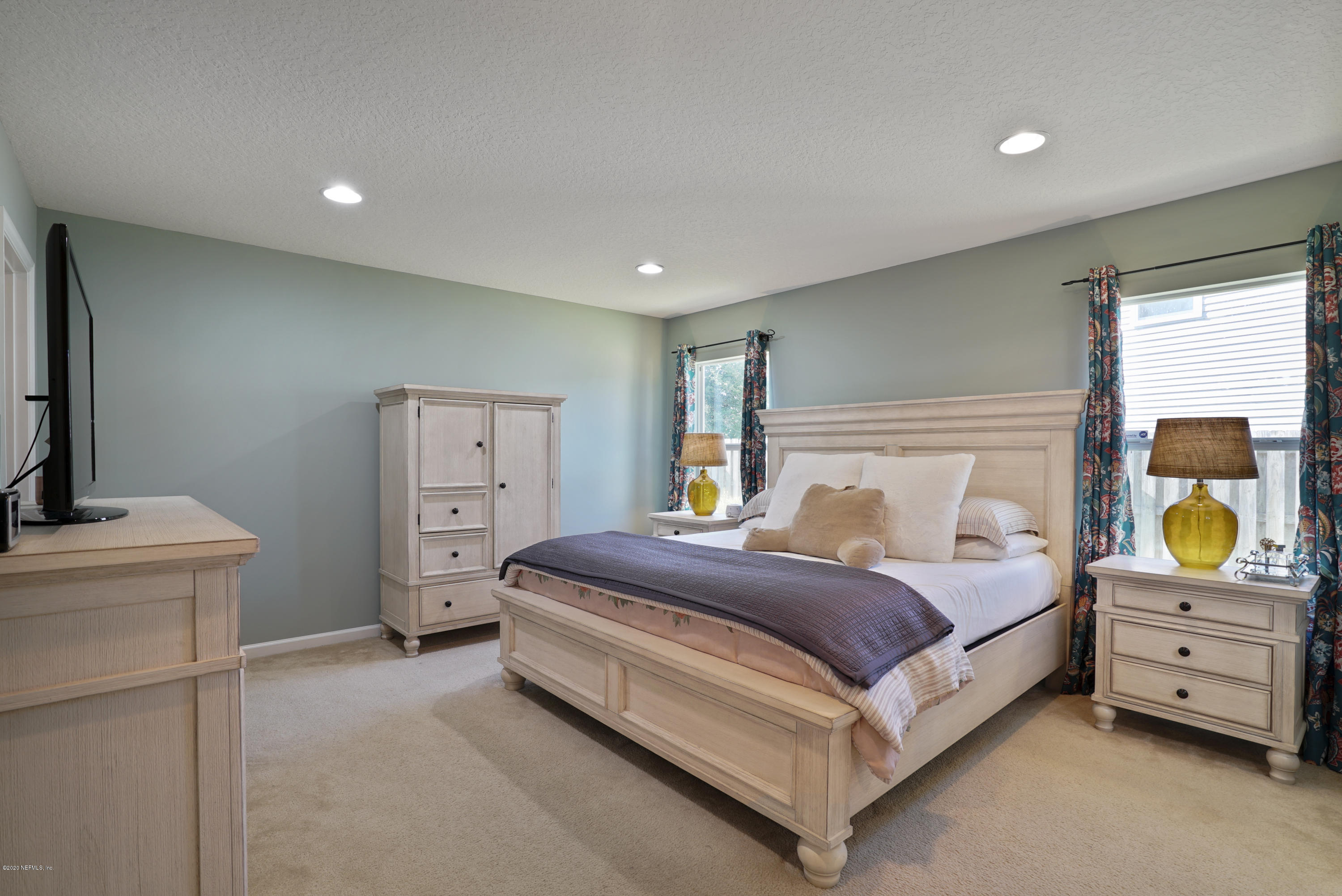 4447 Oak Moss Loop Middleburg, FL 32068 - Photo 15 of 36 a bedroom with a bed and a dresser