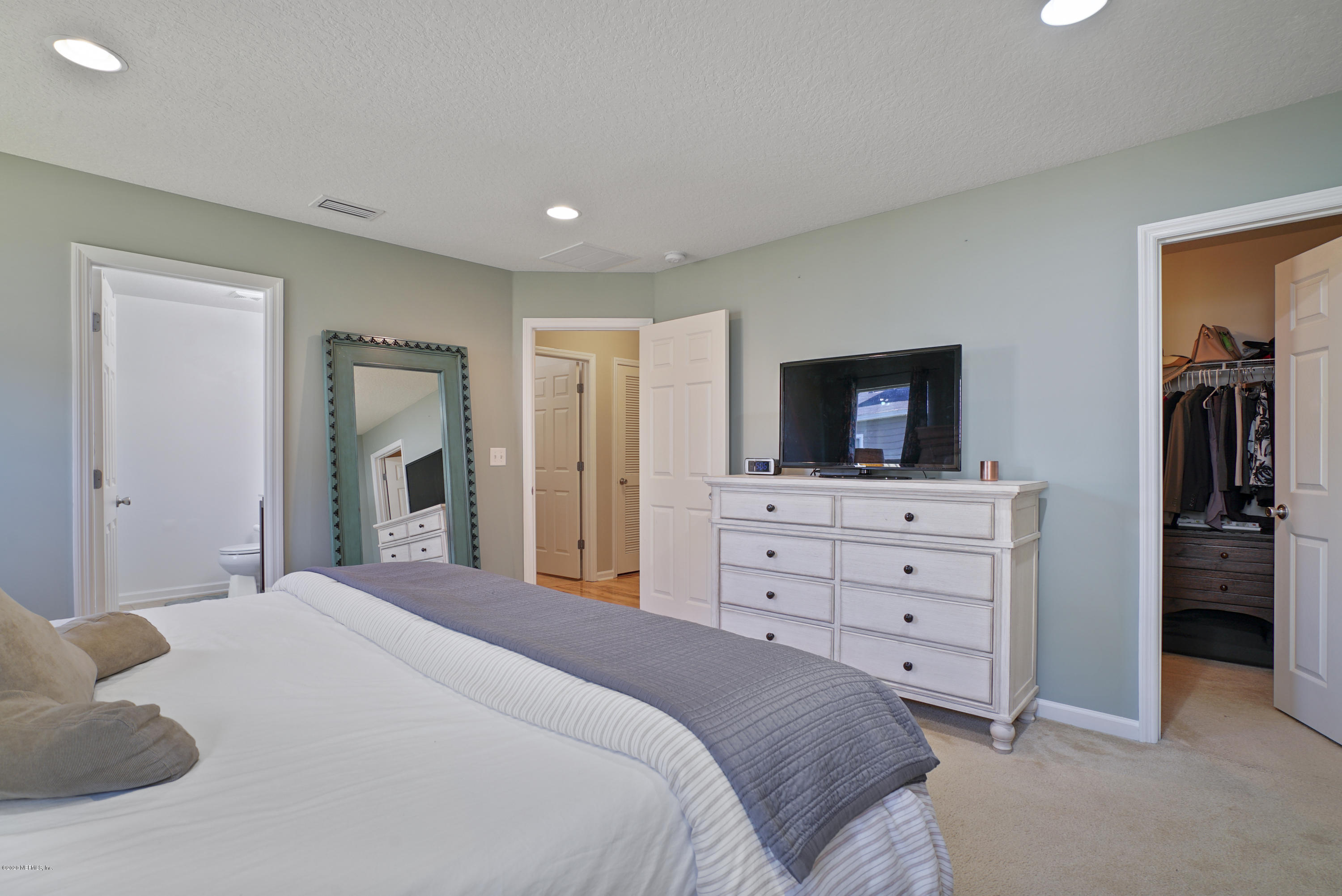 4447 Oak Moss Loop Middleburg, FL 32068 - Photo 17 of 36 a bedroom with a bed and a television