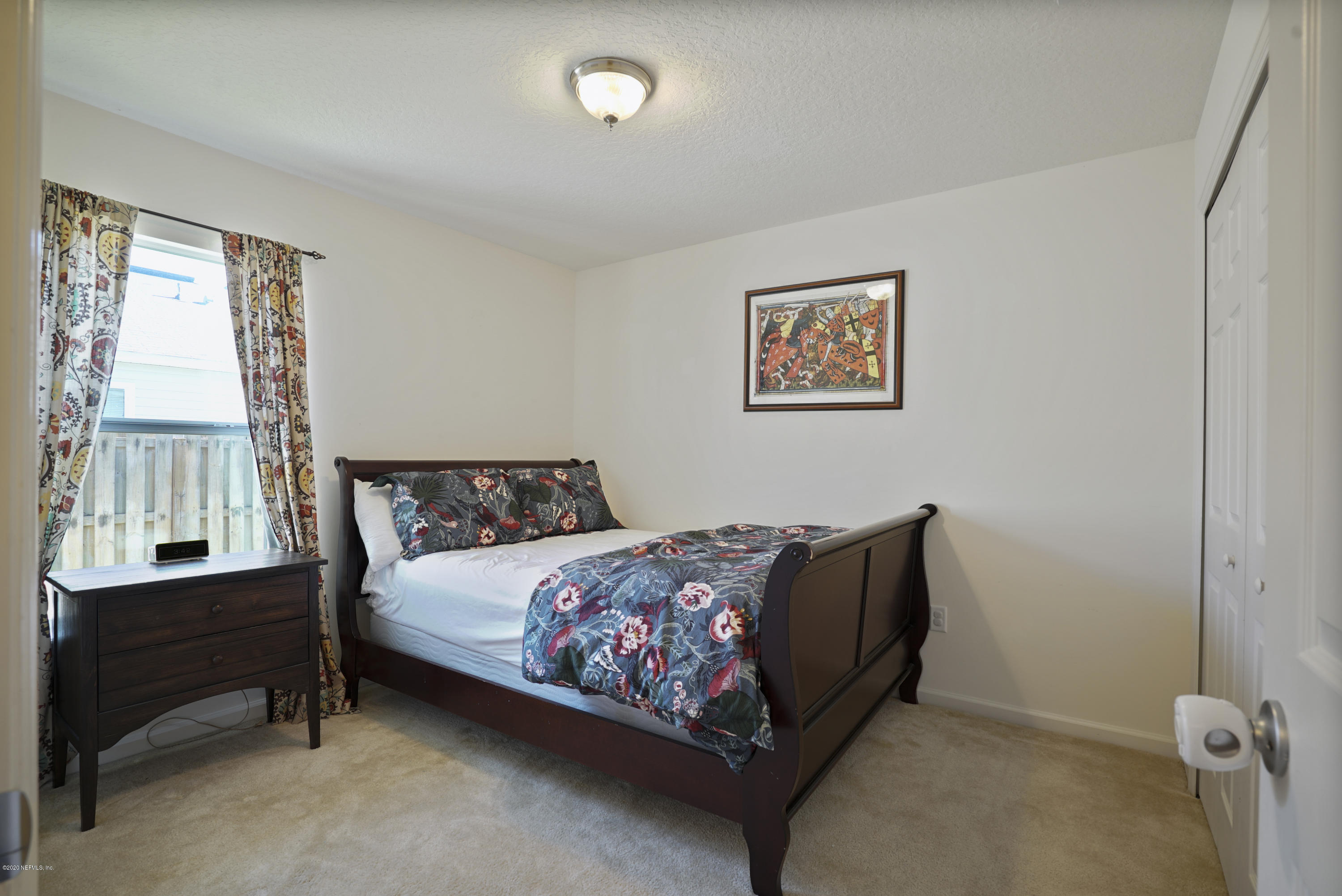 4447 Oak Moss Loop Middleburg, FL 32068 - Photo 21 of 36 a bedroom with a bed and a window