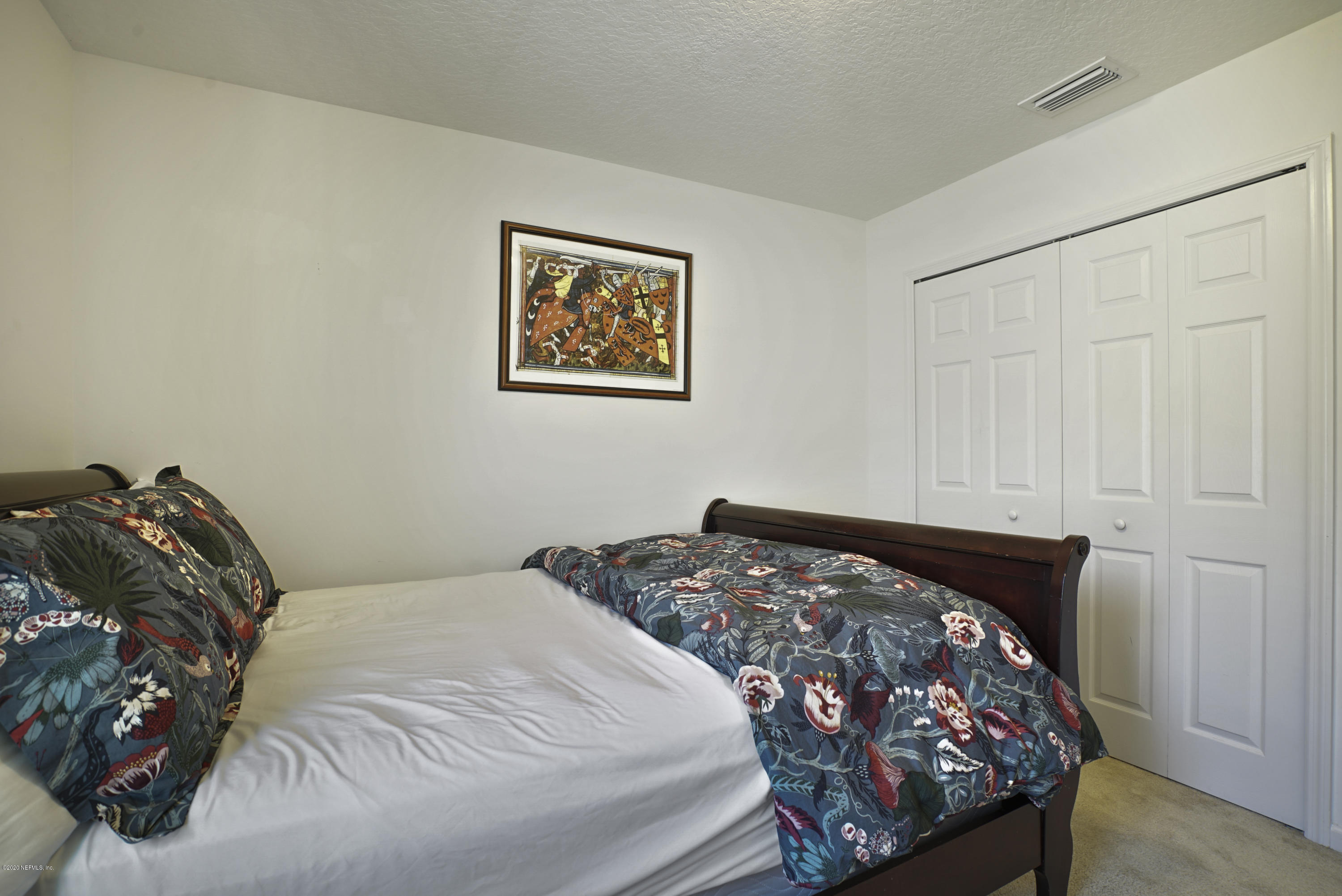 4447 Oak Moss Loop Middleburg, FL 32068 - Photo 22 of 36 a bed sitting in a bedroom next to a bedroom
