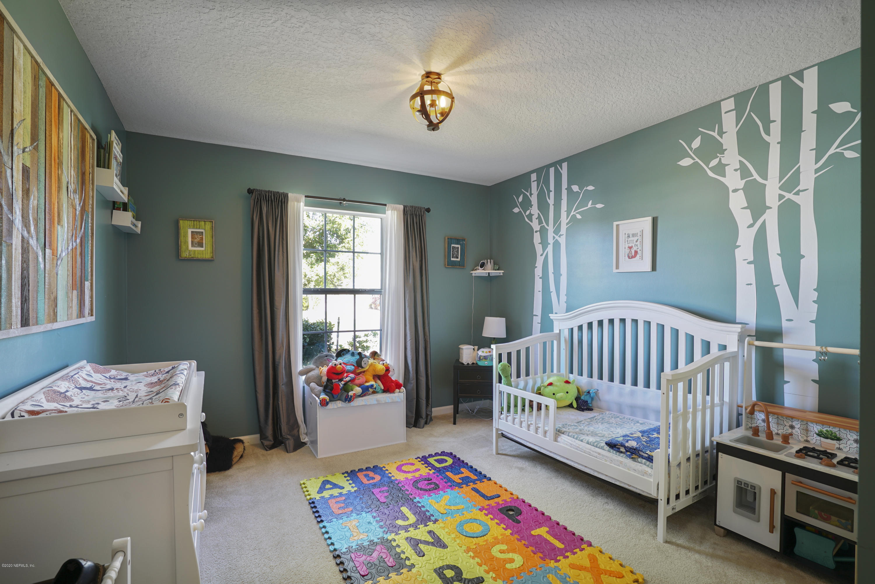 4447 Oak Moss Loop Middleburg, FL 32068 - Photo 23 of 36 a bedroom with a bed and a window