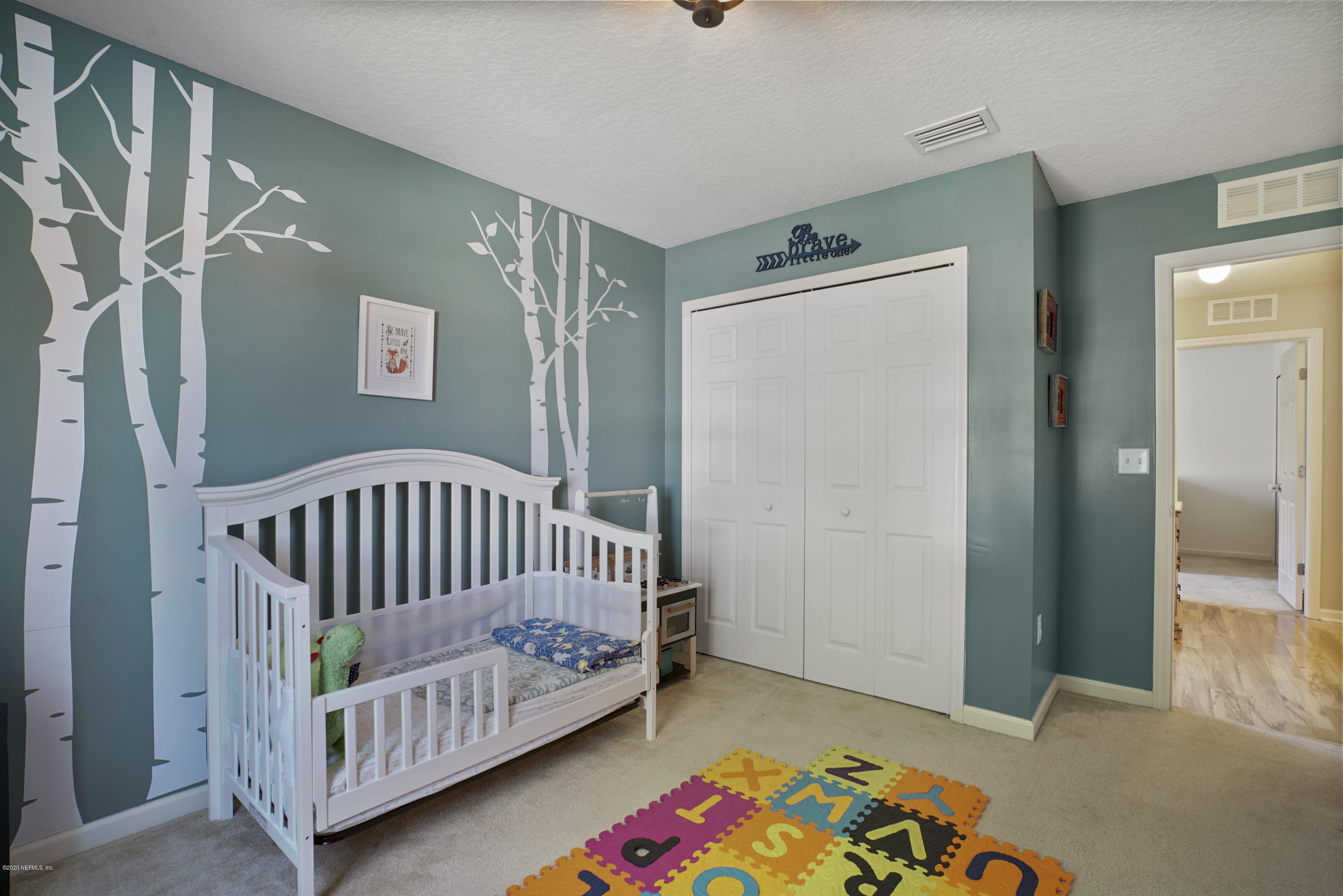 4447 Oak Moss Loop Middleburg, FL 32068 - Photo 24 of 36 a bedroom with a baby crib and a window