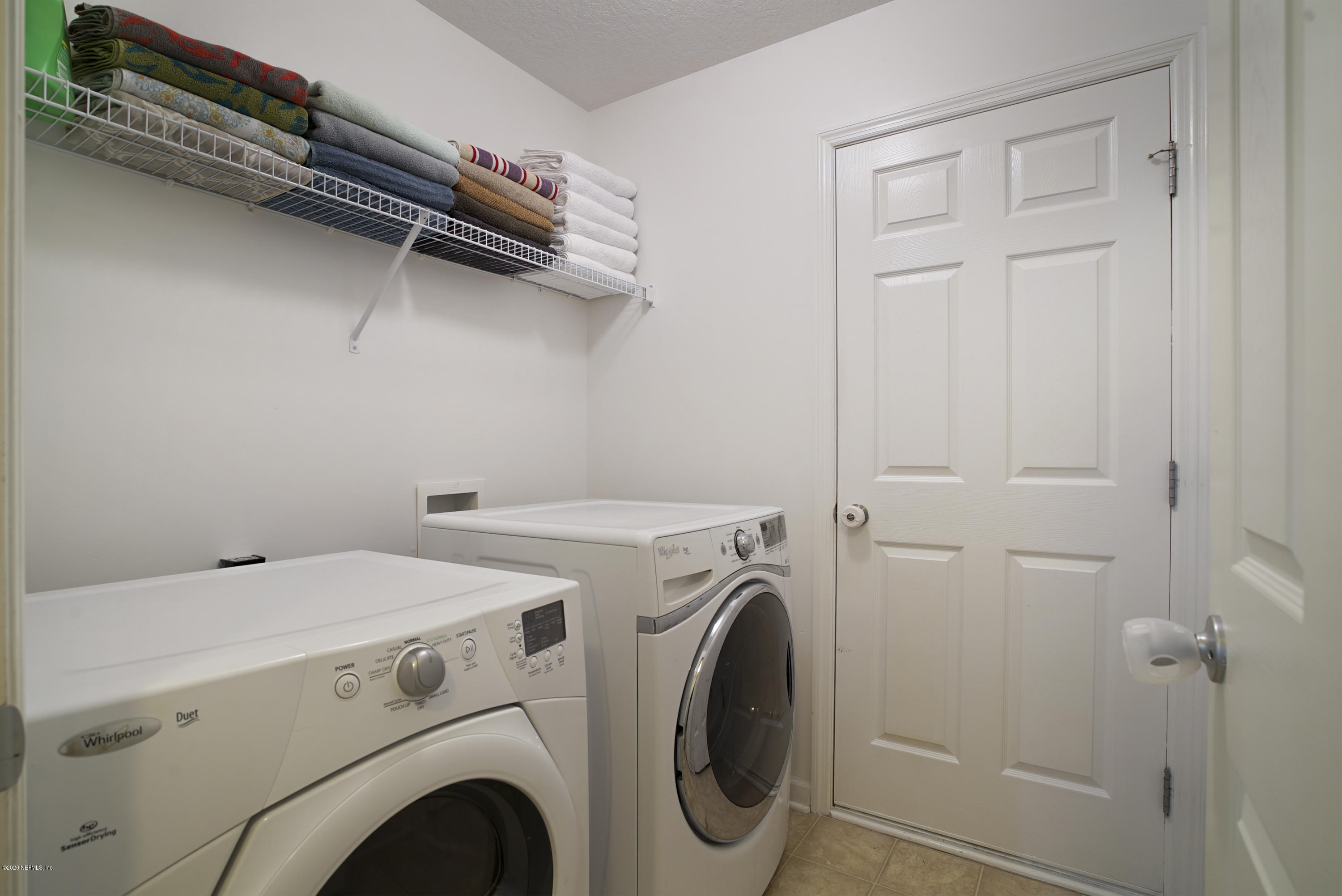 4447 Oak Moss Loop Middleburg, FL 32068 - Photo 26 of 36 a utility room with dryer and washer