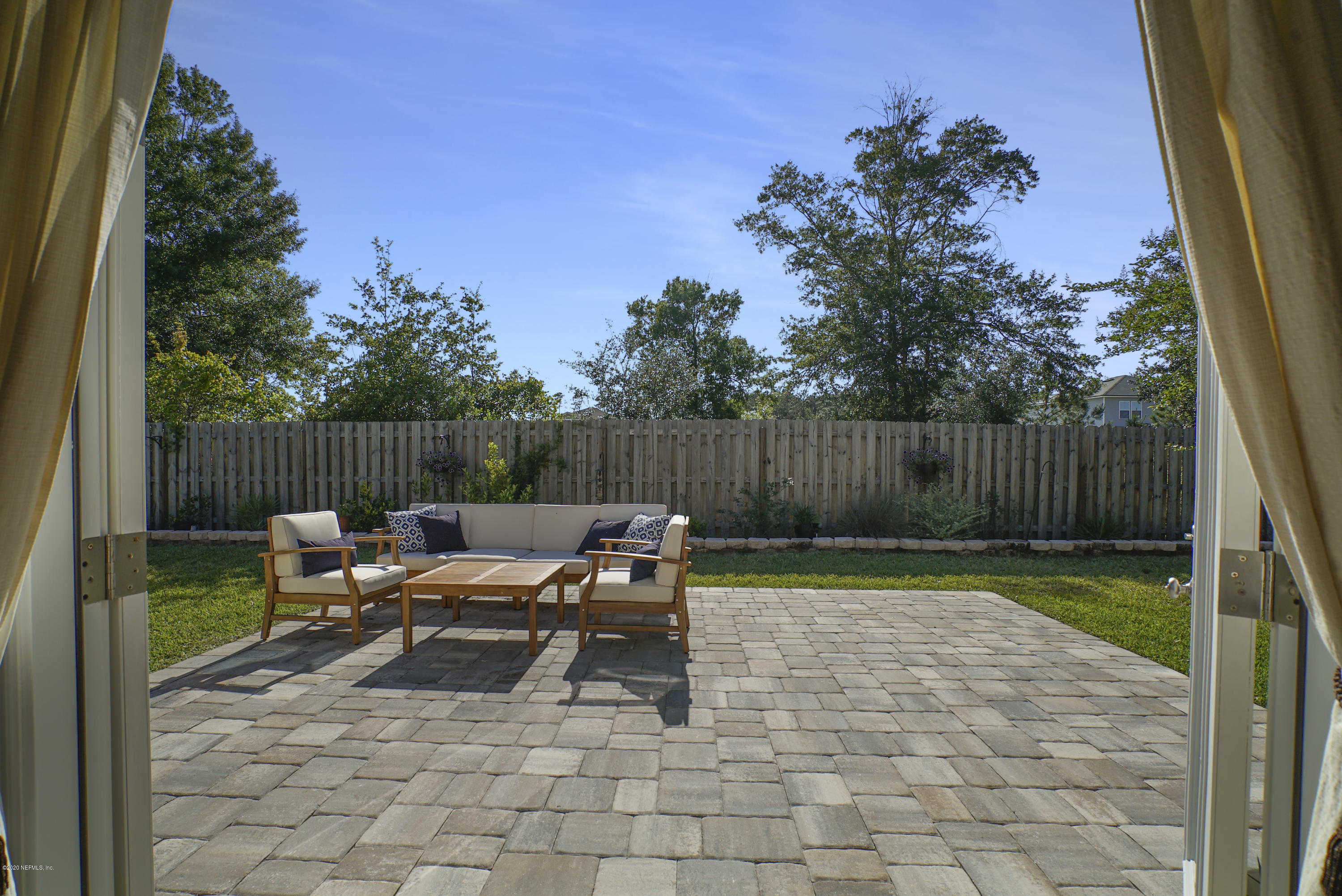 4447 Oak Moss Loop Middleburg, FL 32068 - Photo 27 of 36 a backyard of a house with table and chairs