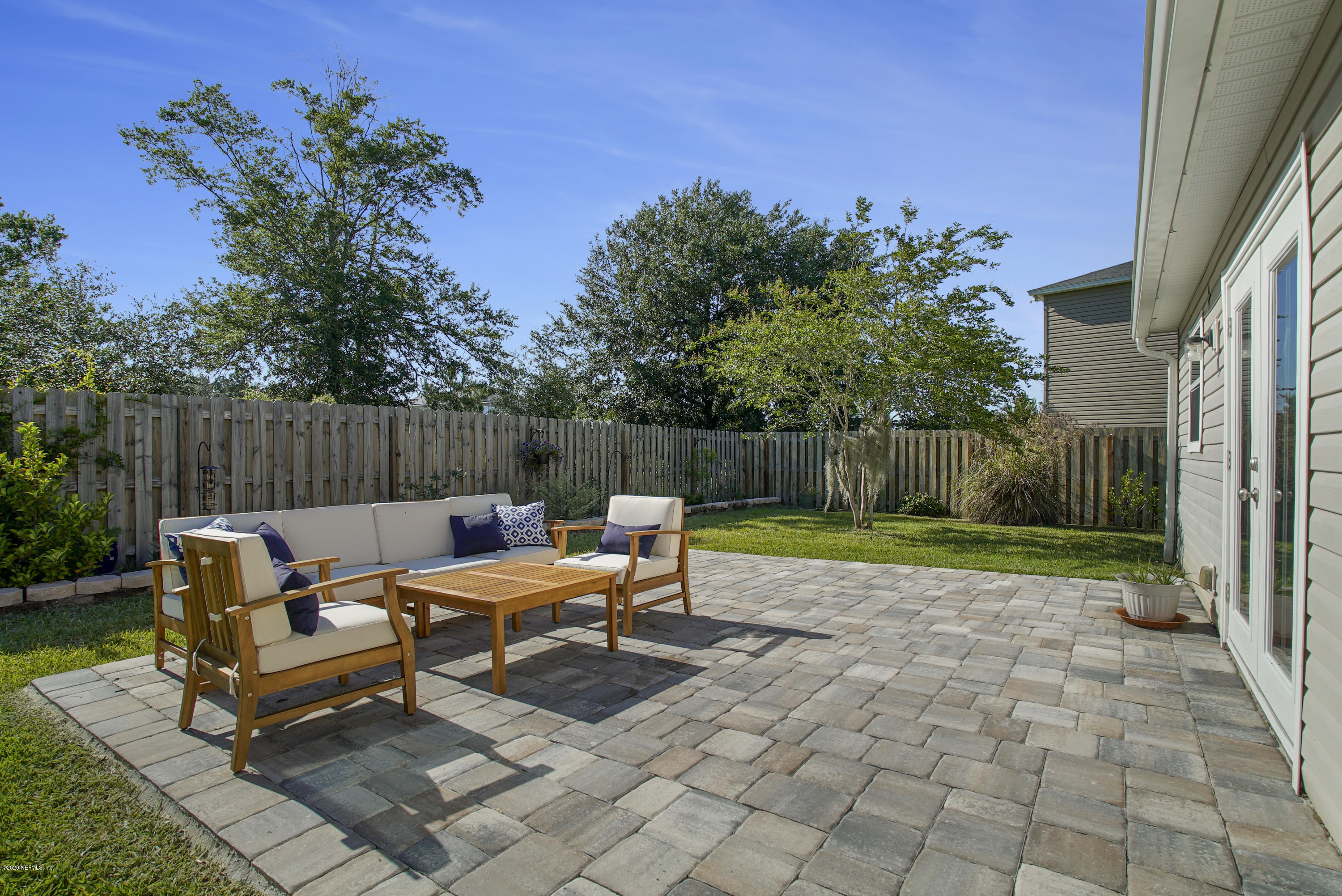 4447 Oak Moss Loop Middleburg, FL 32068 - Photo 28 of 36 a backyard of a house with table and chairs