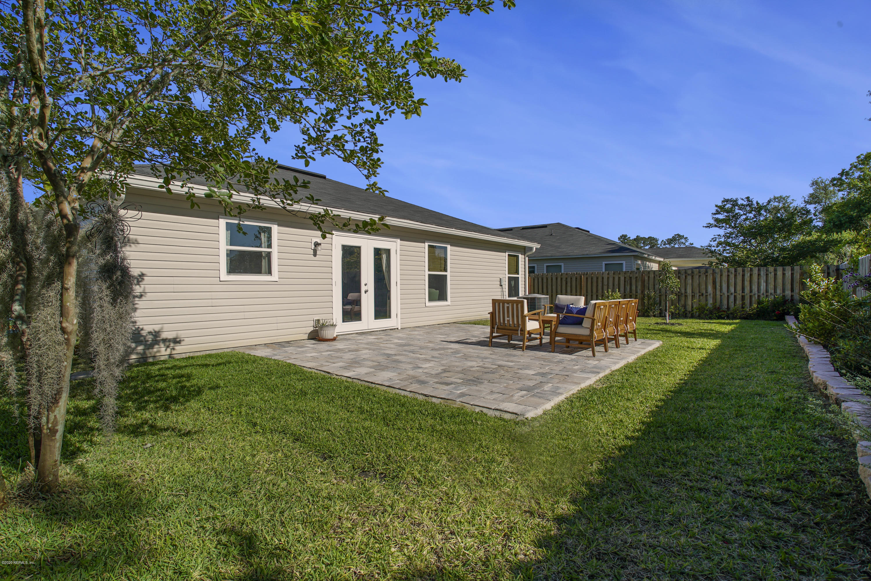 4447 Oak Moss Loop Middleburg, FL 32068 - Photo 30 of 36 a front view of a house with a garden and yard