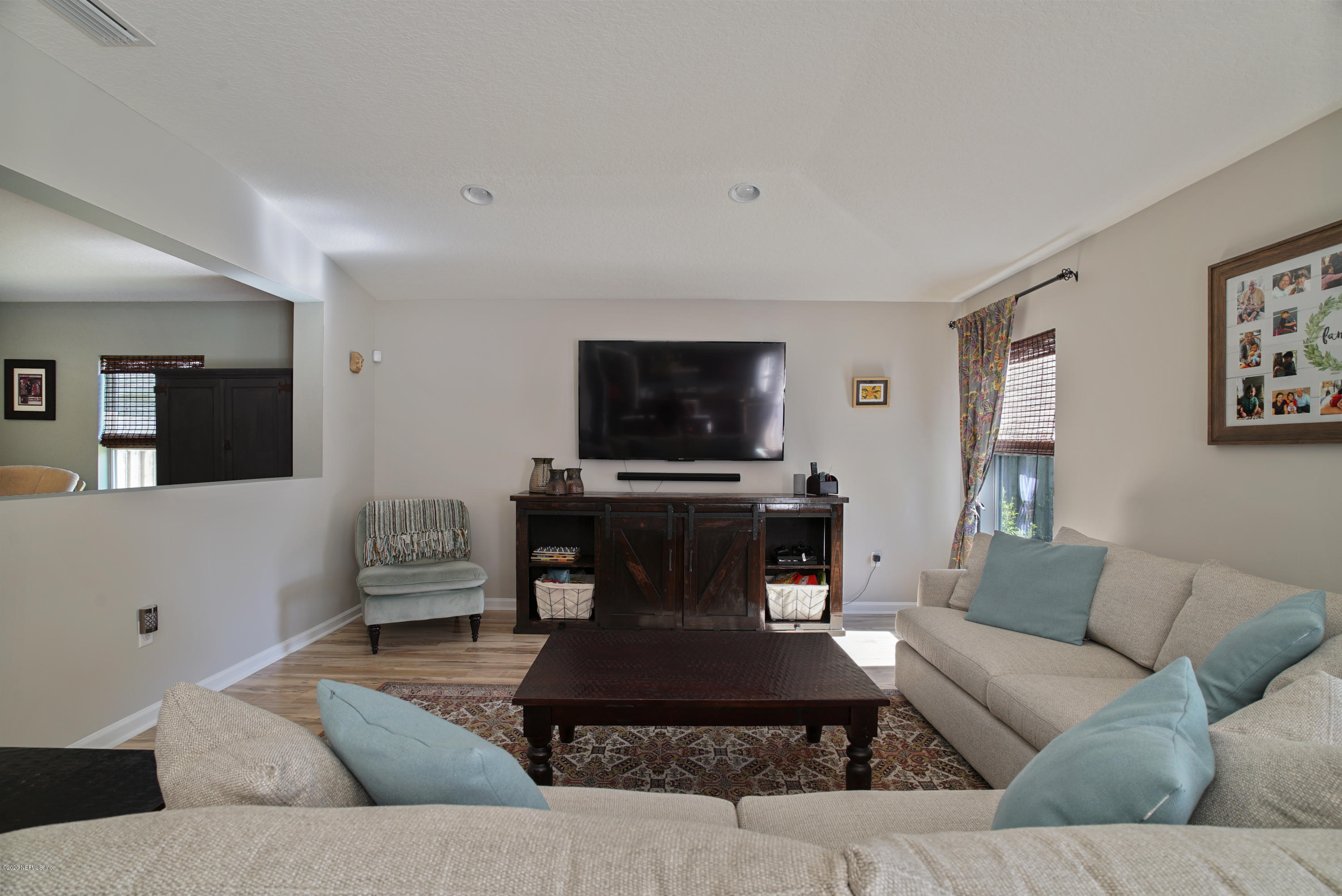 4447 Oak Moss Loop Middleburg, FL 32068 - Photo 3 of 36 a living room with furniture and a flat screen tv