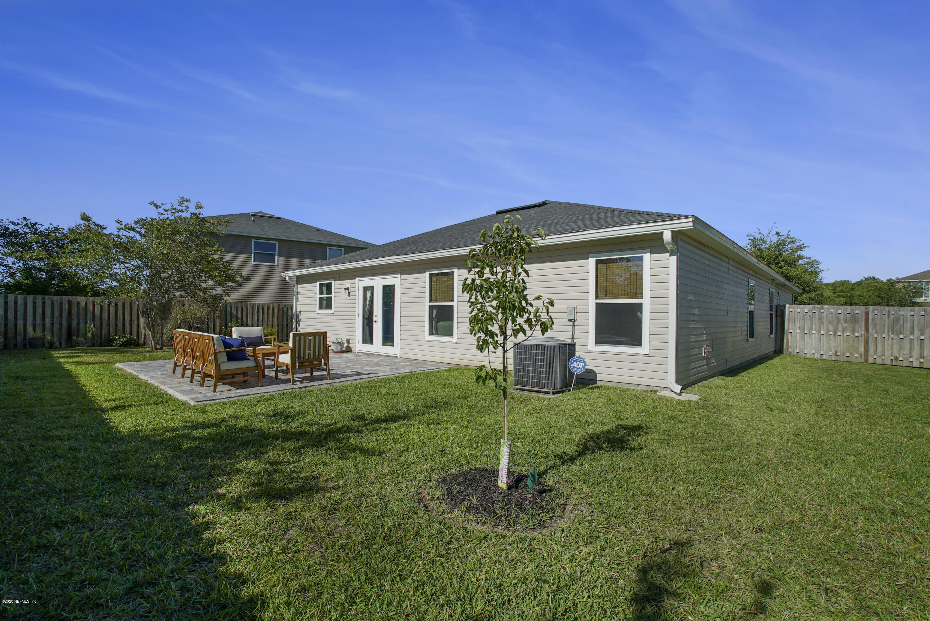 4447 Oak Moss Loop Middleburg, FL 32068 - Photo 31 of 36 a front view of a house with a garden and yard