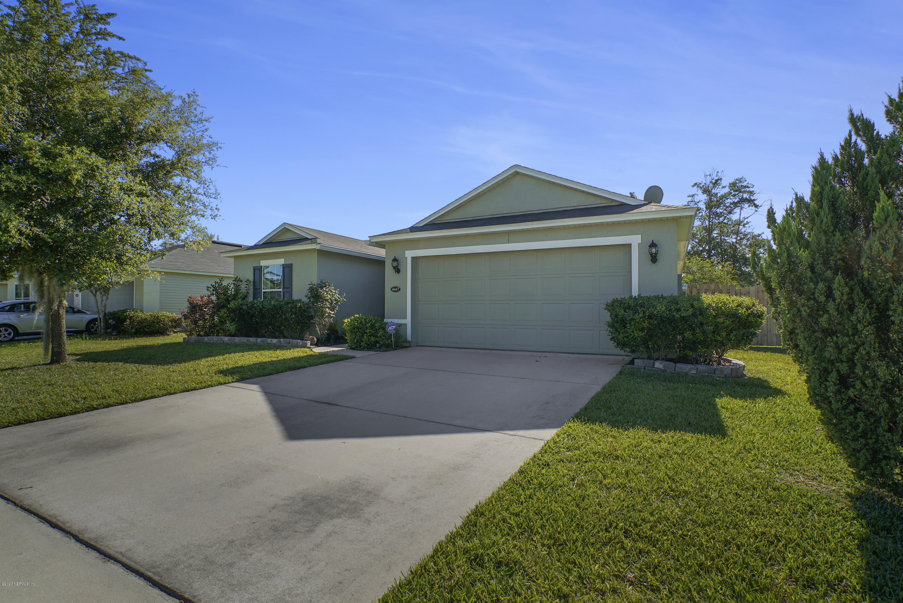 4447 Oak Moss Loop Middleburg, FL 32068 - Photo 35 of 36 a front view of a house with a yard and garage