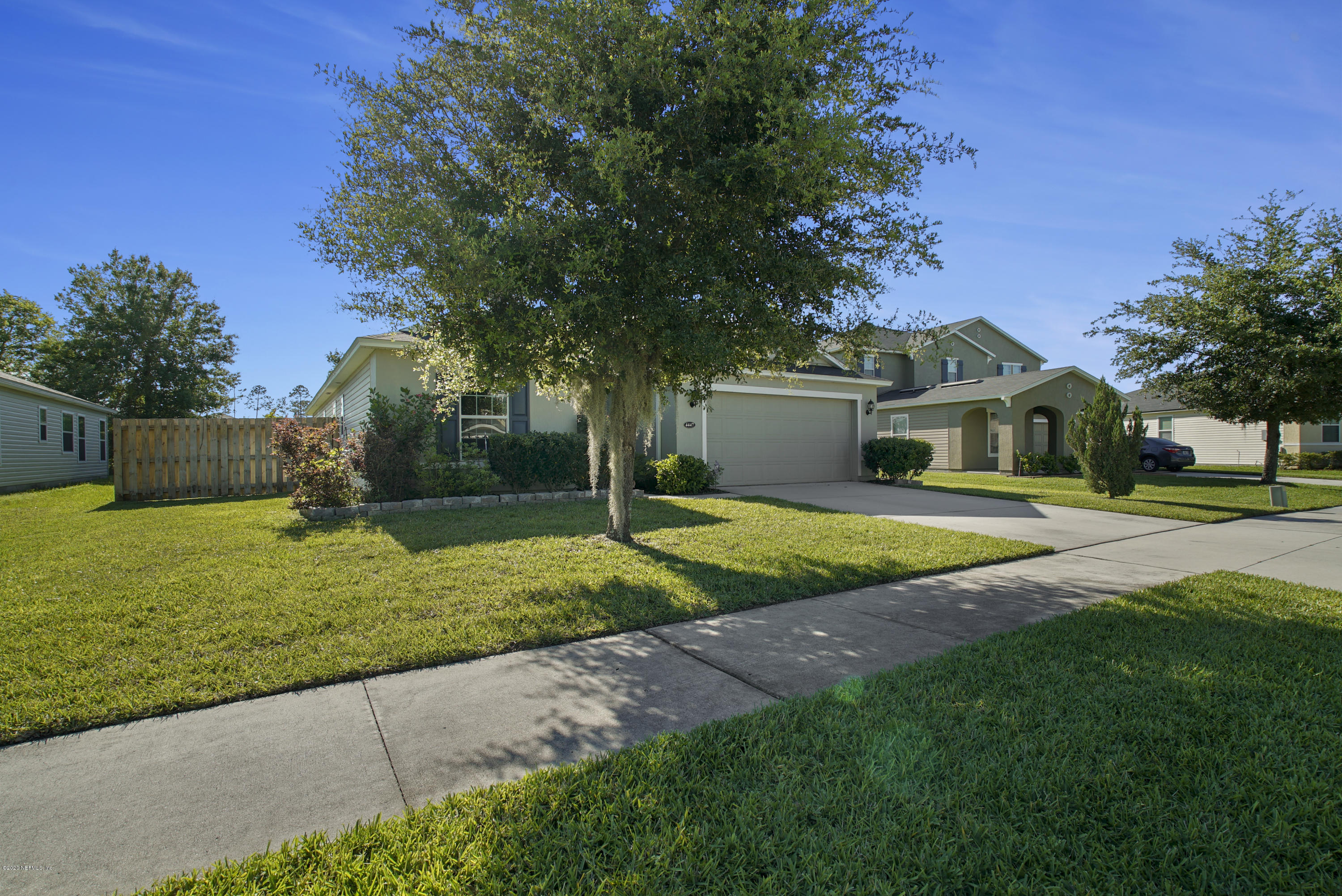 4447 Oak Moss Loop Middleburg, FL 32068 - Photo 36 of 36 a front view of a house with garden