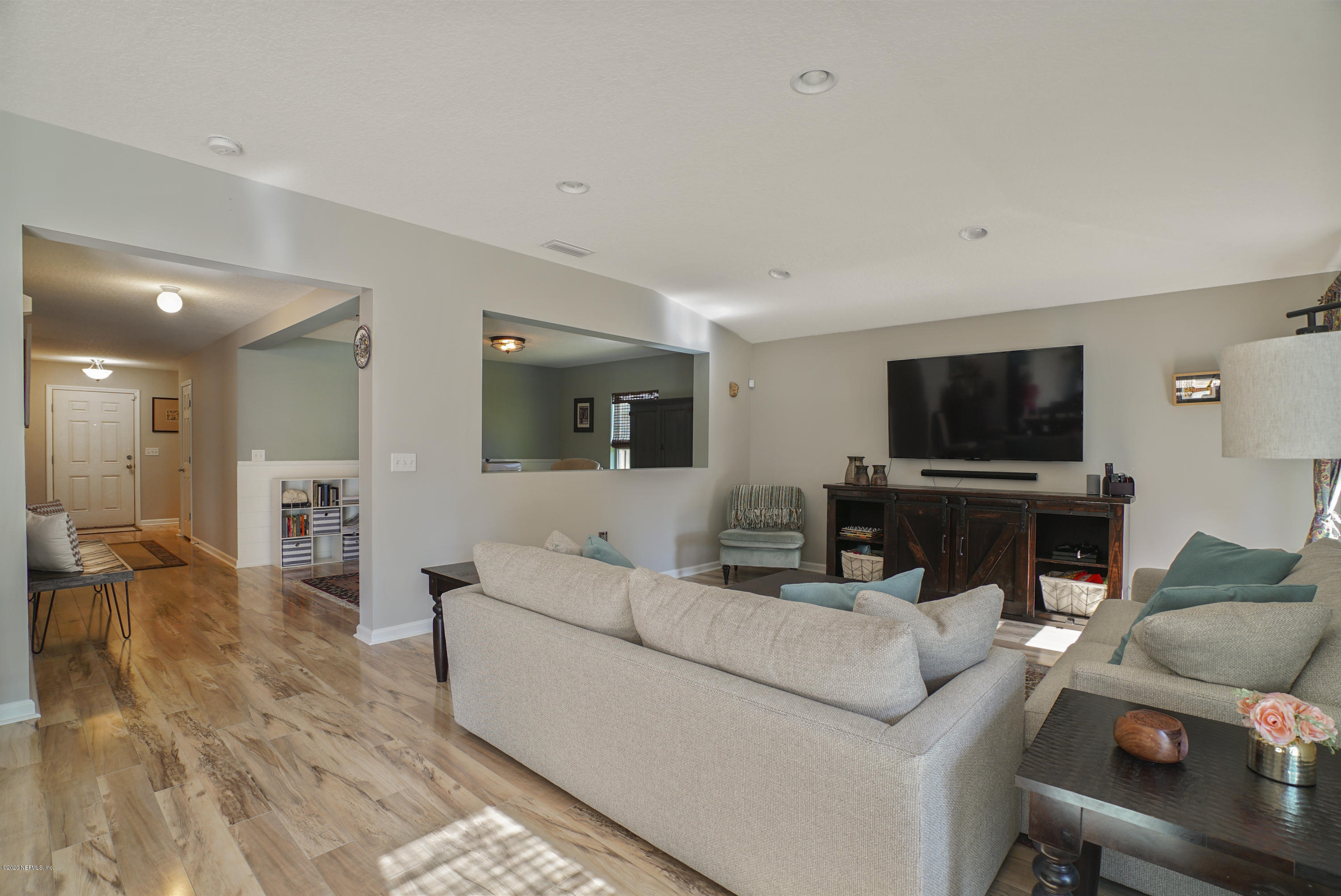 4447 Oak Moss Loop Middleburg, FL 32068 - Photo 4 of 36 a living room with furniture and a flat screen tv