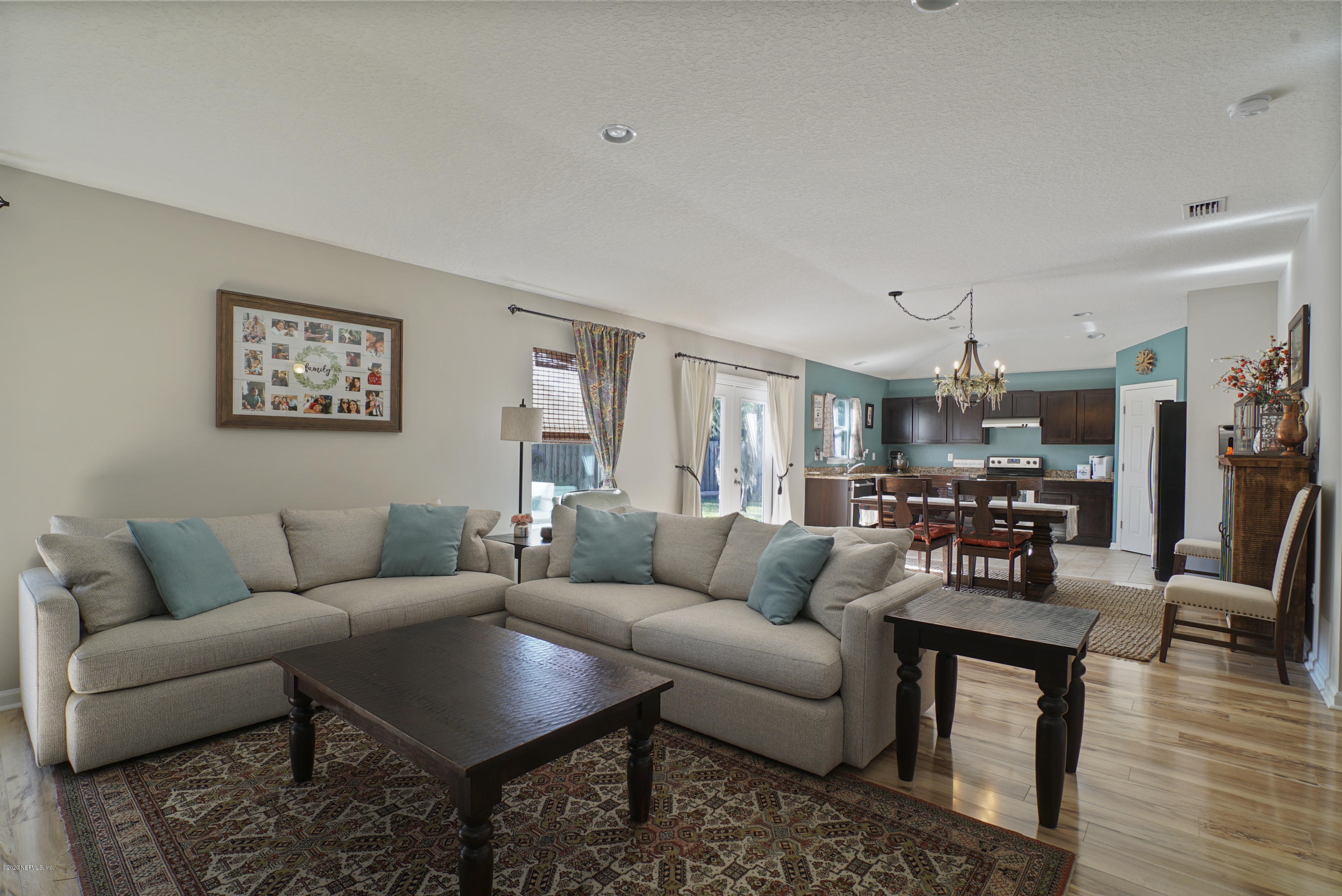 4447 Oak Moss Loop Middleburg, FL 32068 - Photo 5 of 36 a living room with furniture and wooden floor
