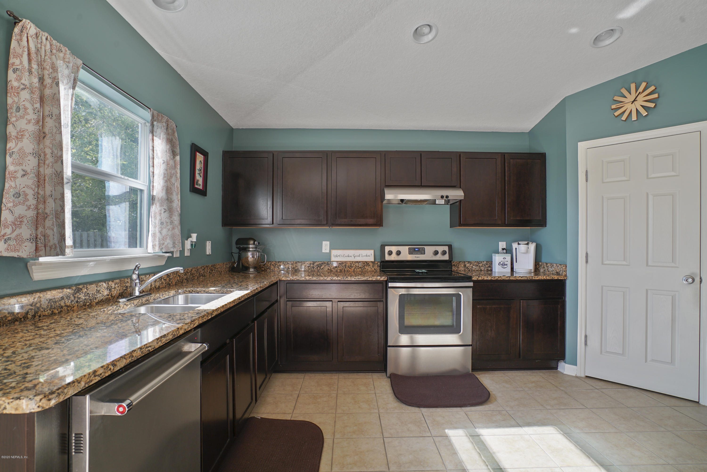 4447 Oak Moss Loop Middleburg, FL 32068 - Photo 7 of 36 a kitchen with a sink stove and microwave