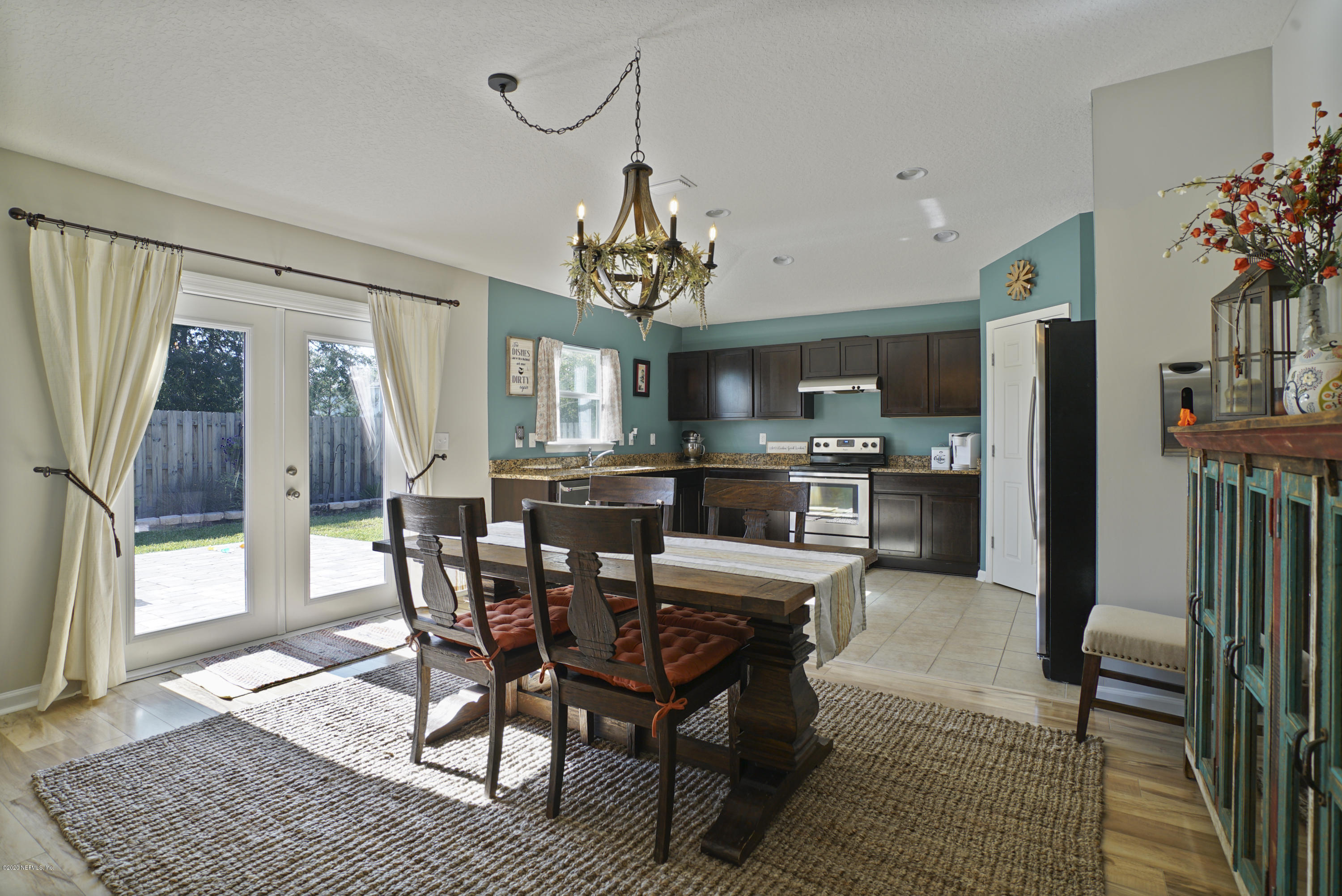 4447 Oak Moss Loop Middleburg, FL 32068 - Photo 8 of 36 a view of a dining room with furniture and a chandelier