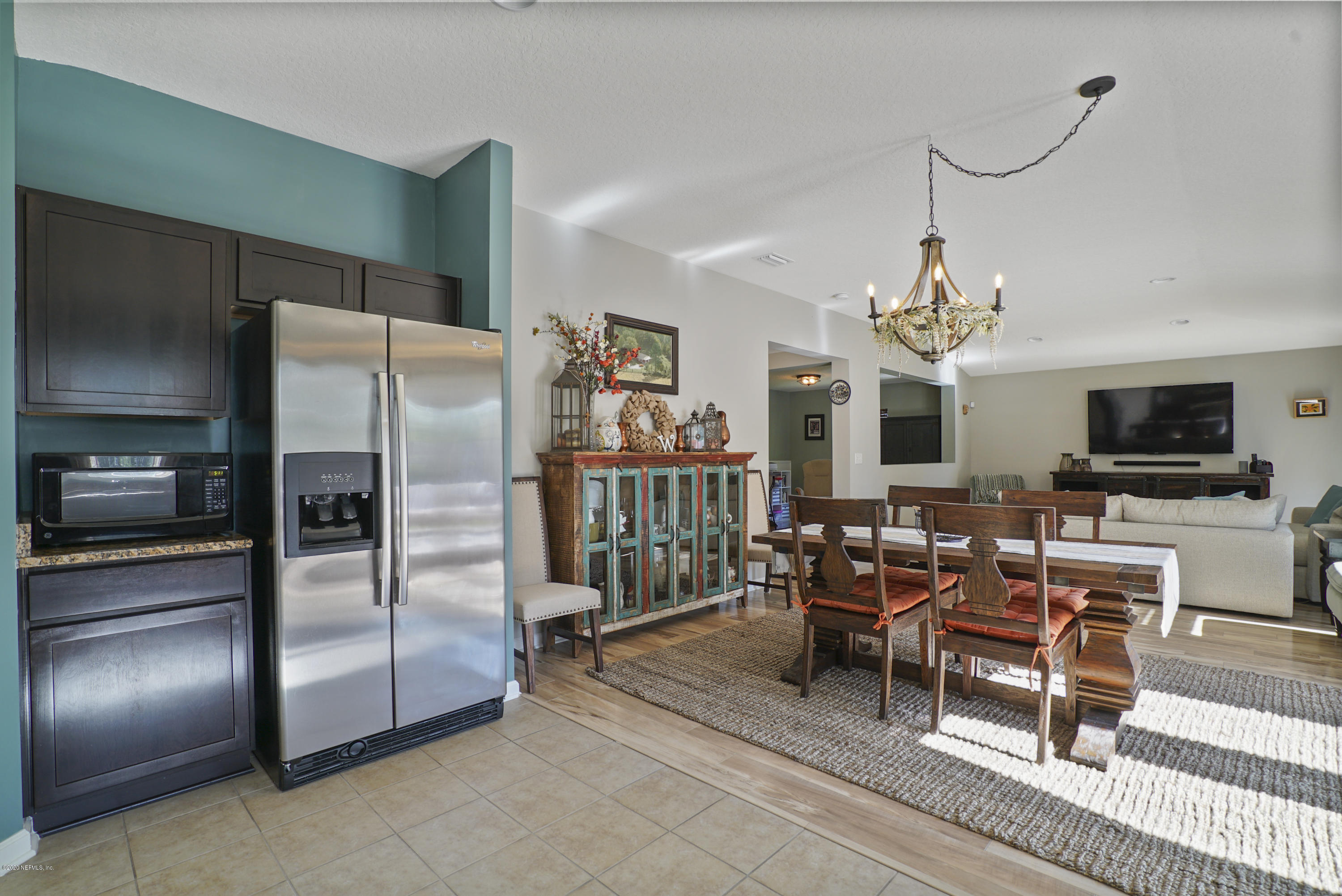 4447 Oak Moss Loop Middleburg, FL 32068 - Photo 10 of 36 a view of a dining room with furniture a chandelier and wooden floor
