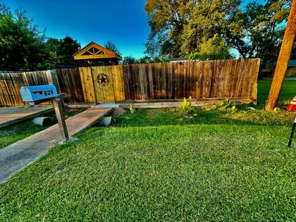 a view of a back yard with a bench