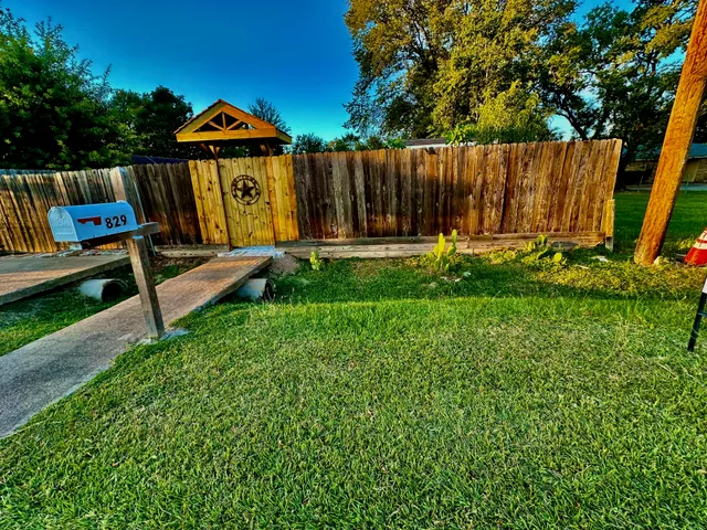 a view of a back yard with a bench