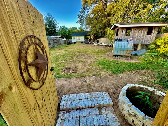 a view of a backyard with furniture and a garden
