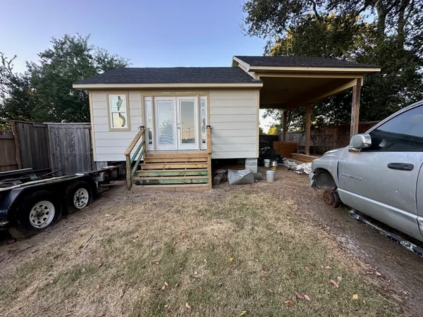 a view of a car park in front of house