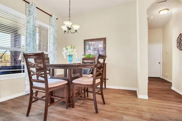 a view of a dining room with furniture and wooden floor