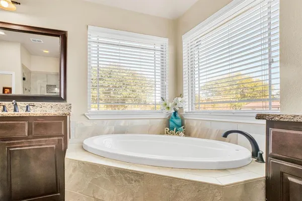 a bath tub sitting in a bathroom next to a window