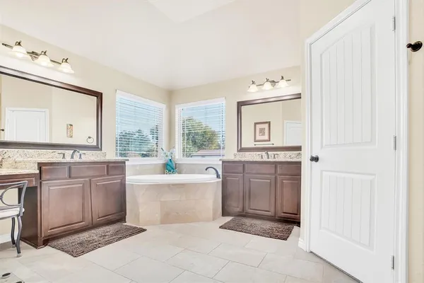 a large white kitchen with cabinets and stainless steel appliances
