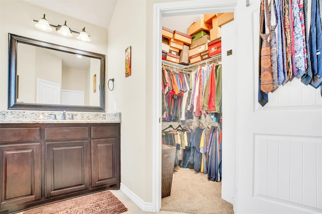 14095 Pecan Lane Forney, TX 75126 - Photo 21 of 40 a bathroom with a sink vanity and a mirror