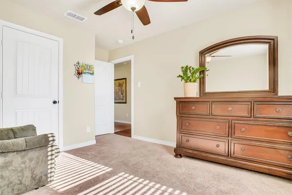 a living room with furniture and a mirror