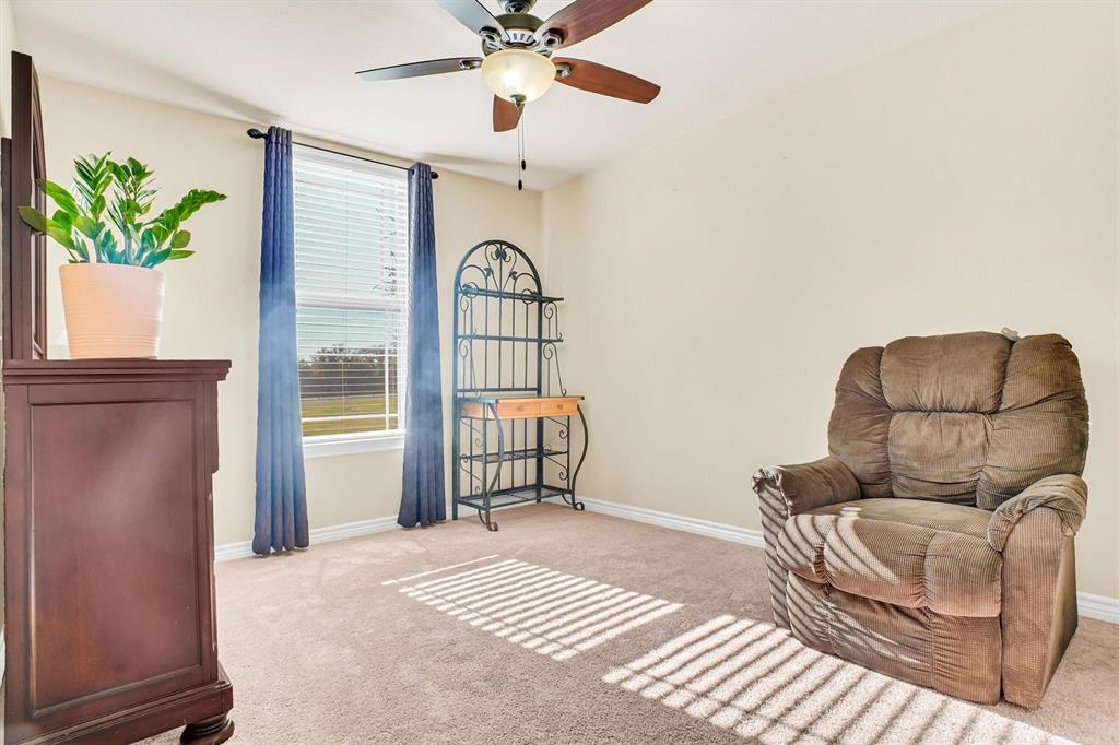 14095 Pecan Lane Forney, TX 75126 - Photo 31 of 40 a bedroom with a bed and a chandelier