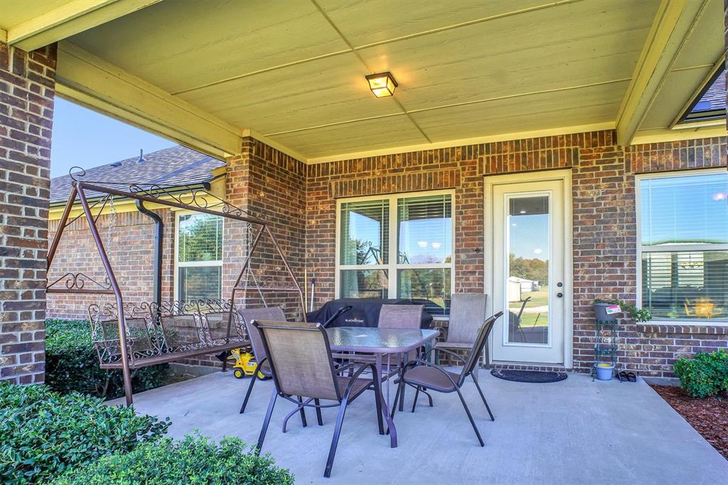 14095 Pecan Lane Forney, TX 75126 - Photo 33 of 40 a patio with table and chairs and potted plants