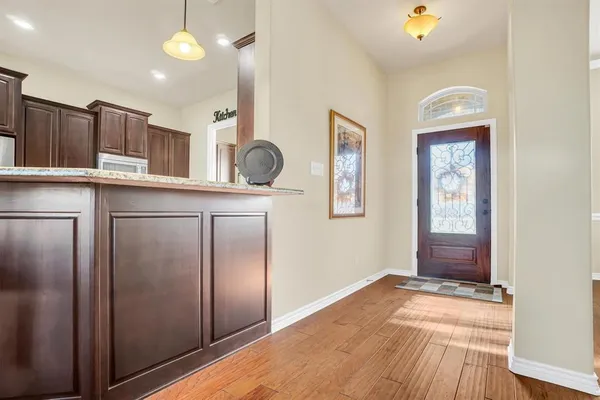 a view of kitchen with wooden floor and seating space