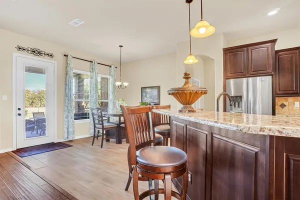 a kitchen with stainless steel appliances granite countertop a sink a stove and a refrigerator