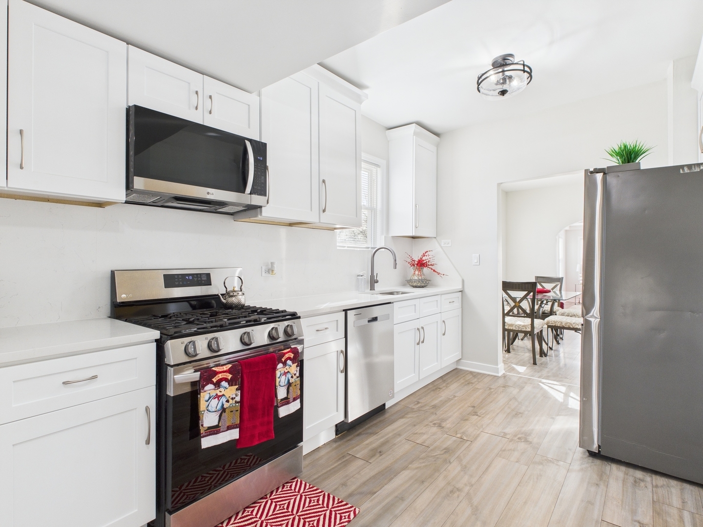 9151 South Normal Avenue Chicago, IL 60620 - Photo 11 of 34 a kitchen with stainless steel appliances a stove a sink and a refrigerator