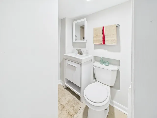 a white toilet sitting next to a bathroom sink