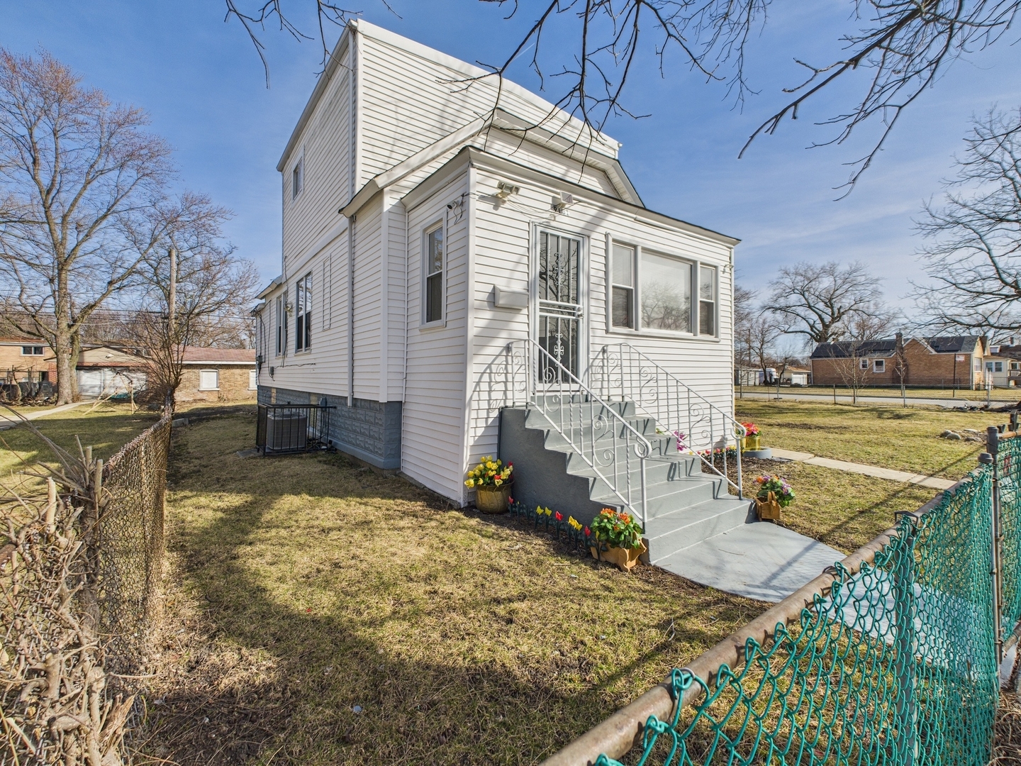 9151 South Normal Avenue Chicago, IL 60620 - Photo 23 of 34 a view of a white house with a yard covered with snow in the outdoor space