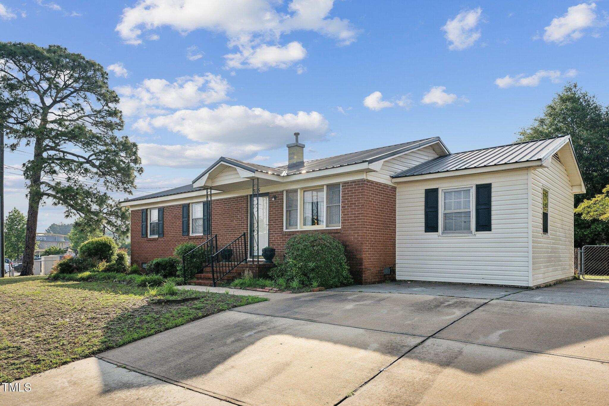 a front view of a house with a garden